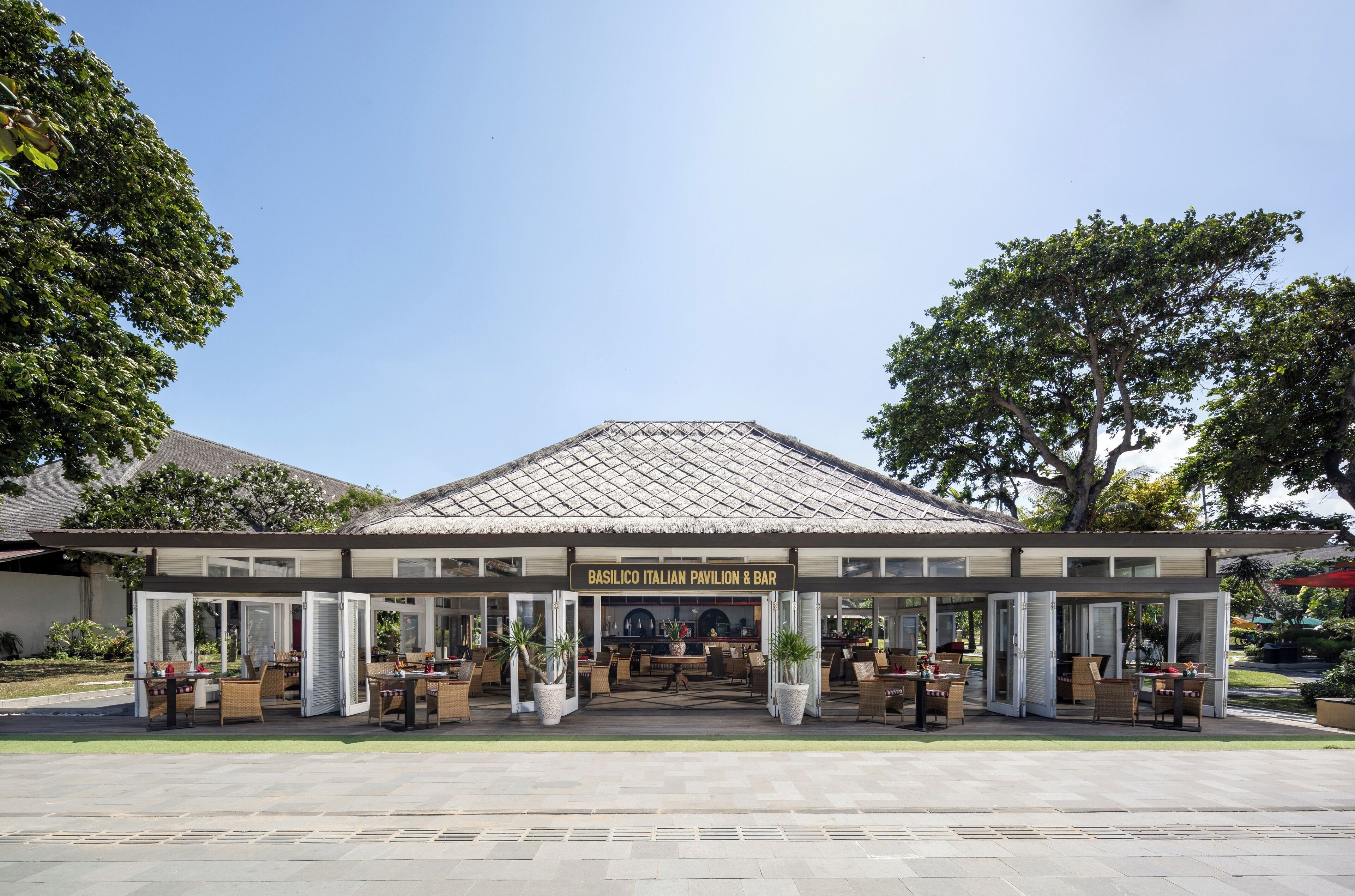 A restaurant with an open patio and outdoor seating.