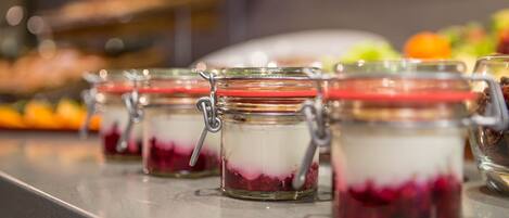 A row of glass jars with metal clasps on a countertop.