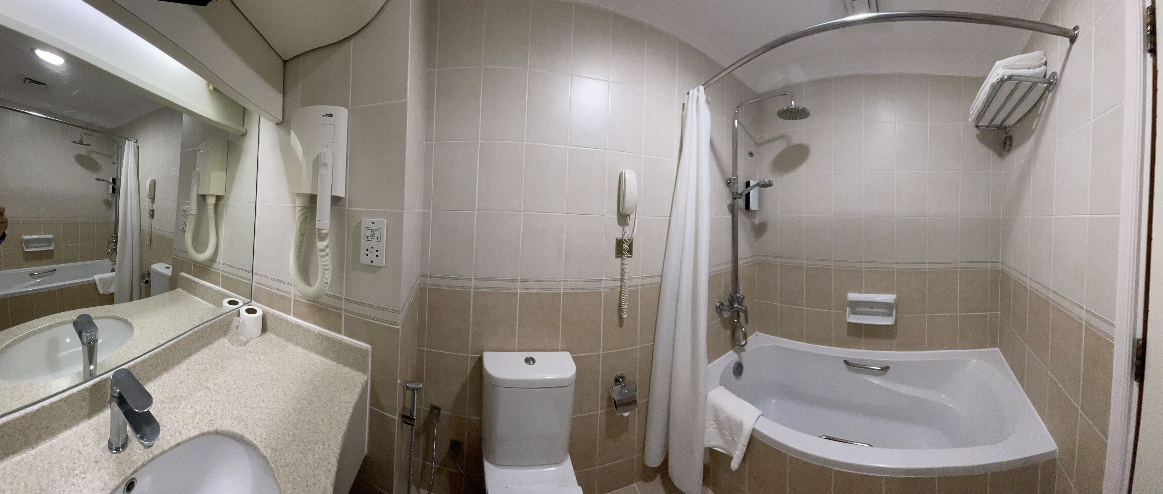 A bathroom with a sink, toilet, shower, and bathtub.
