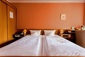 A double bed with white linens, two bedside tables with lamps, and a wooden headboard. - Landhotel Zum Böhm (Roth)
