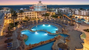 A resort with a large swimming pool, lounge areas, and a view of the sea. - Seagull Beach Resort Families & Couples Only - All Inclusive (Hurghada)