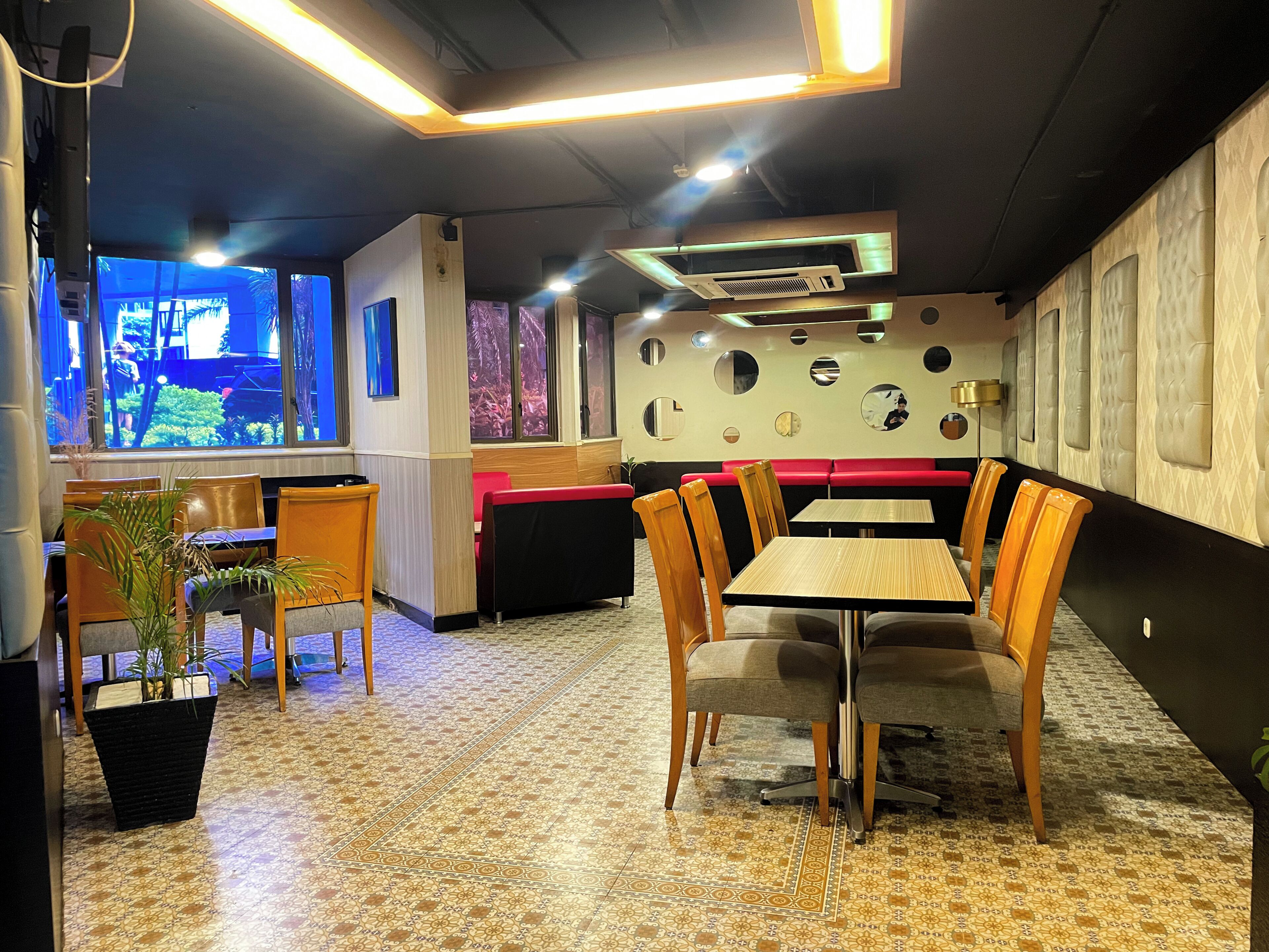 A restaurant interior with a dining area, booths, and a view of the outdoors.