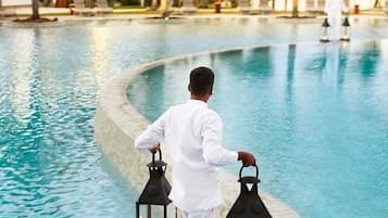 Outdoor pool, open 9:00 AM to 8:00 PM, pool umbrellas, pool loungers
