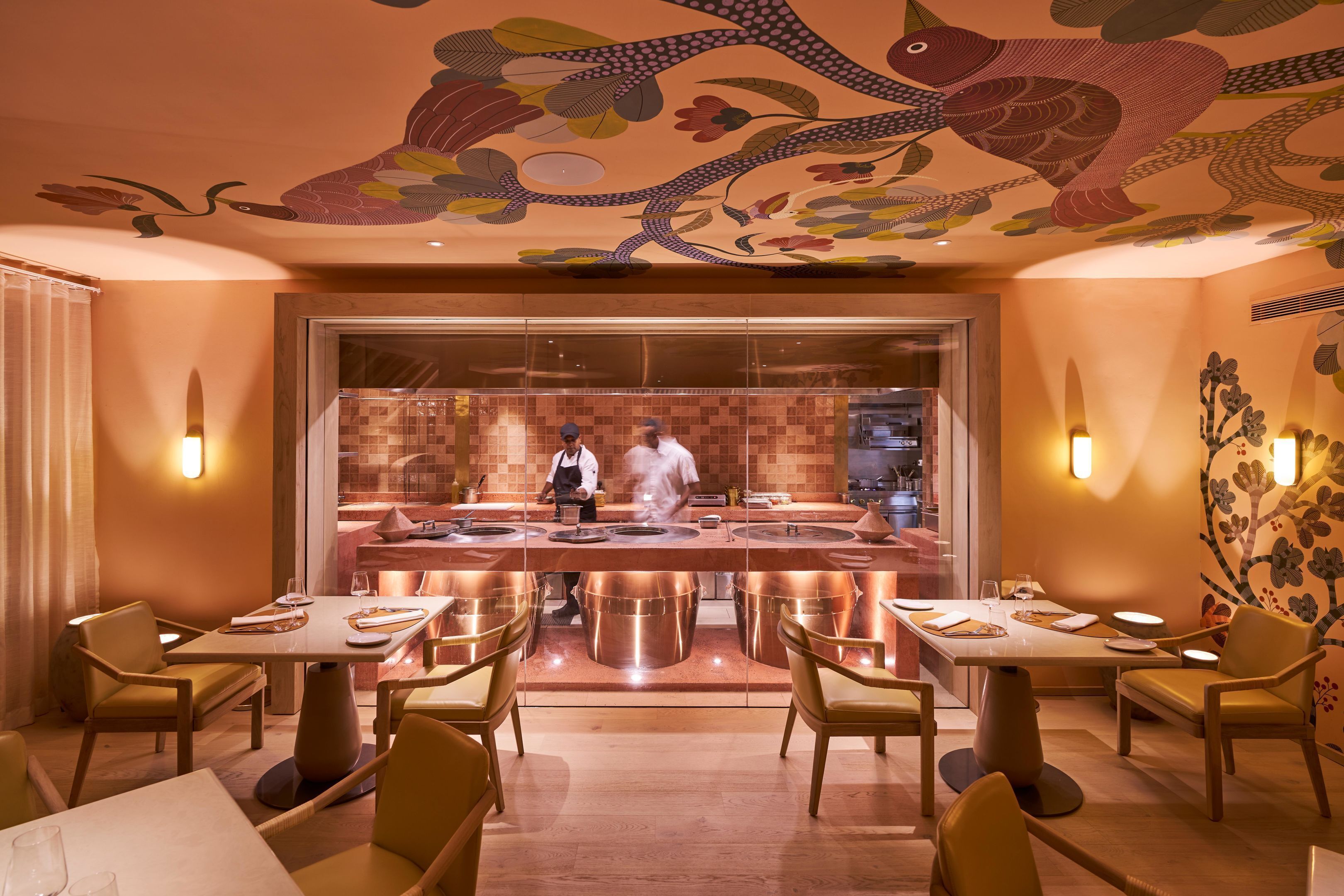 A restaurant with a central bar, tables with chairs, and a decorative ceiling.