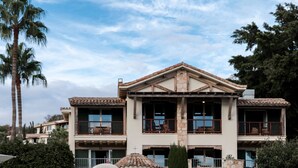 A large, multi-story building with a stone facade and a central courtyard. - Columbia Beach Resort (Pissouri)