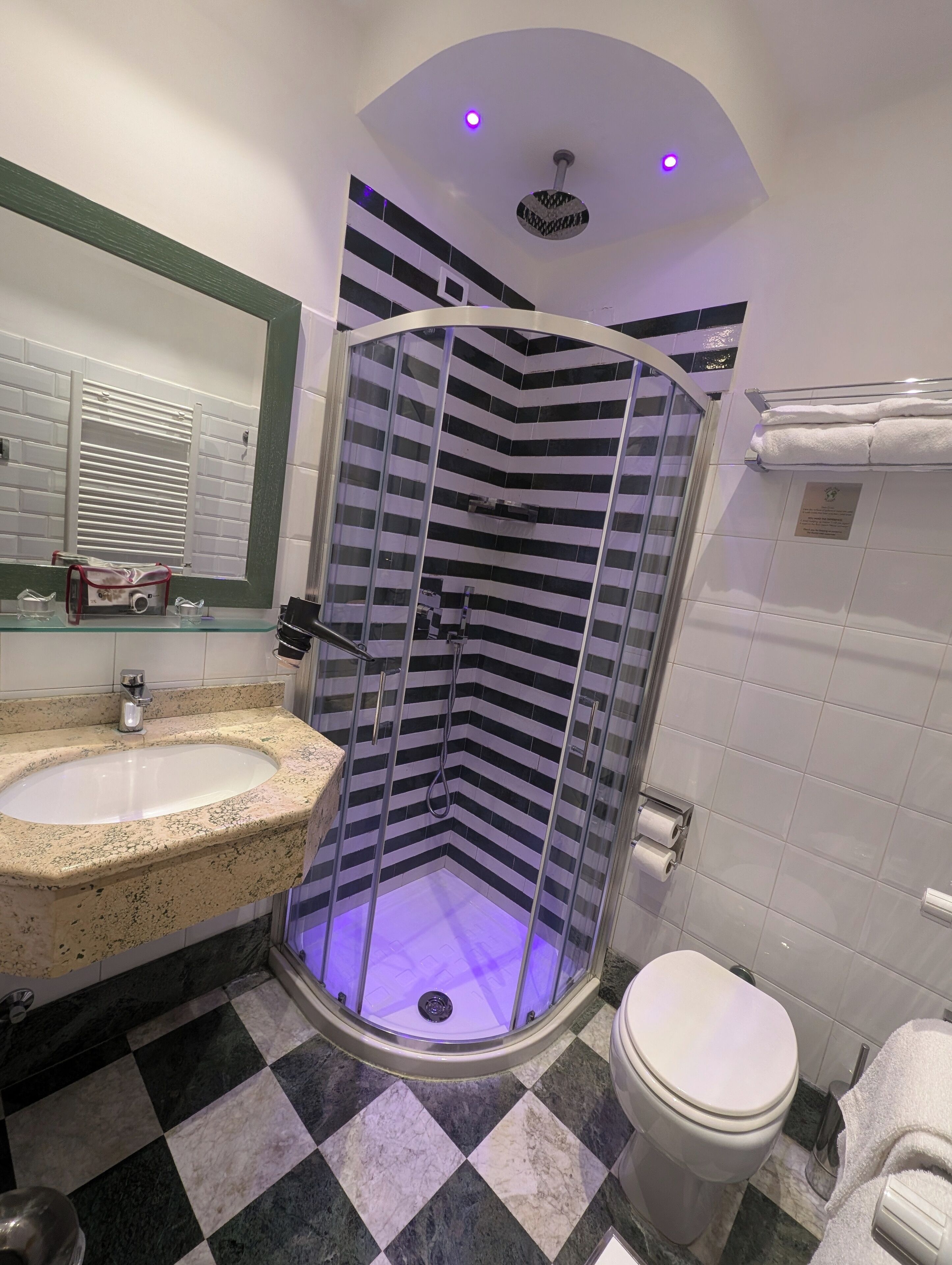 Ein Badezimmer mit Duschkabine, Waschbecken und Toilette.