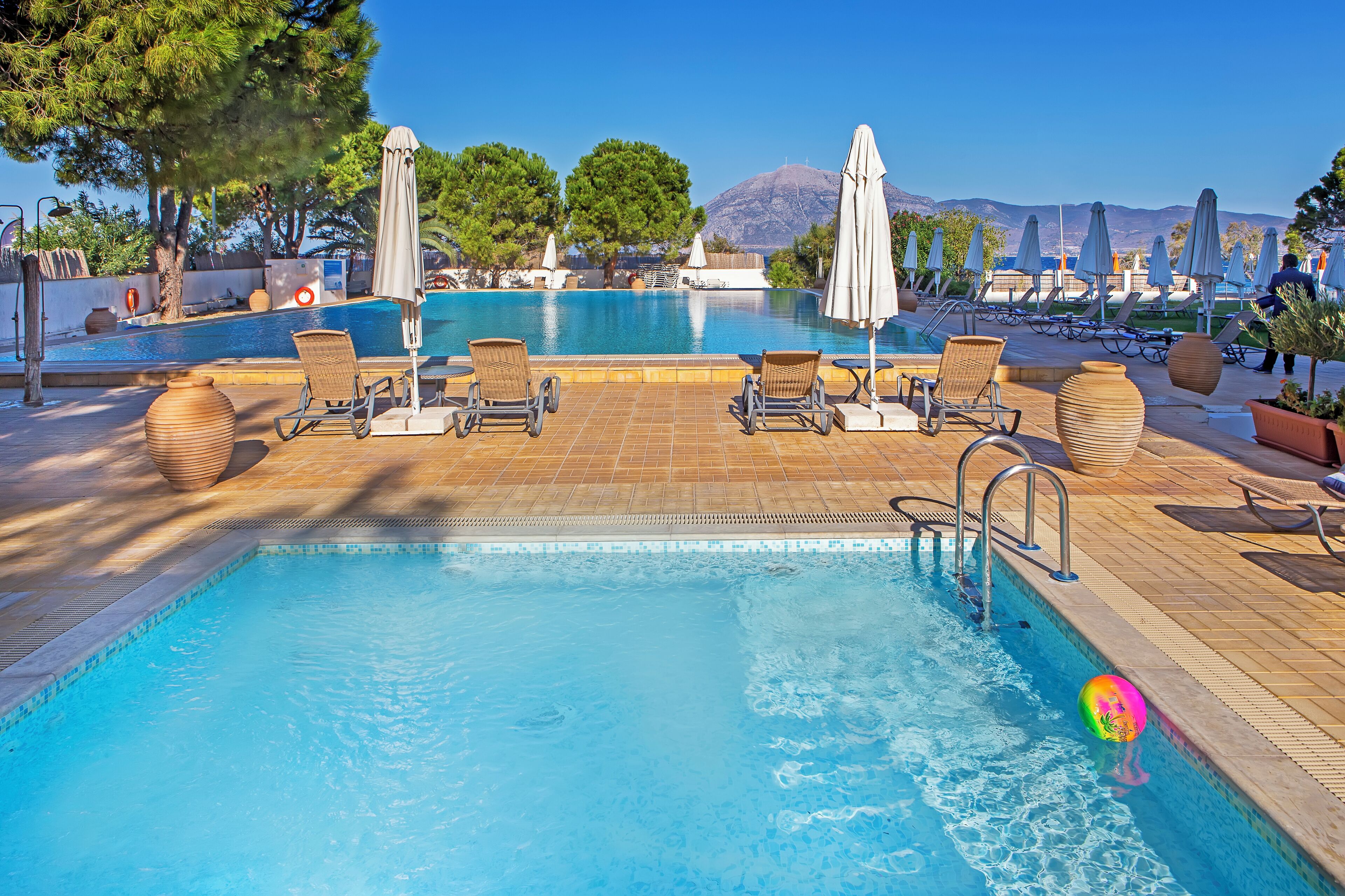 Seasonal outdoor pool, open 11:00 AM to 7:00 PM, pool umbrellas