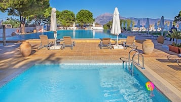 Seasonal outdoor pool, open 11:00 AM to 7:00 PM, pool umbrellas