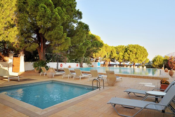 Seasonal outdoor pool, open 11:00 AM to 7:00 PM, pool umbrellas