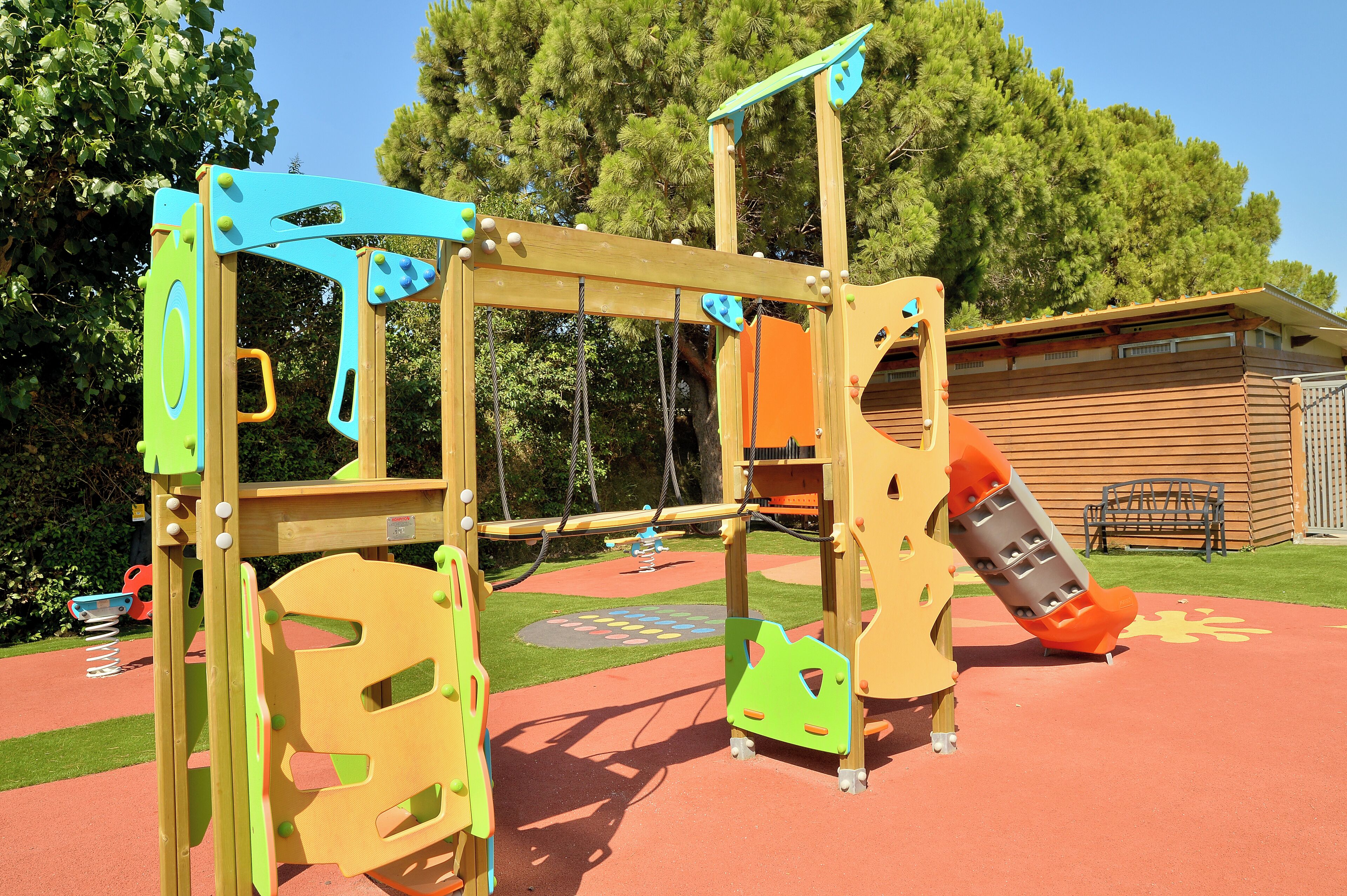 A playground with a slide, swings, and climbing structures.
