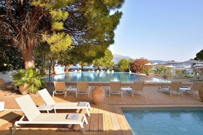 Seasonal outdoor pool, open 11:00 AM to 7:00 PM, pool umbrellas