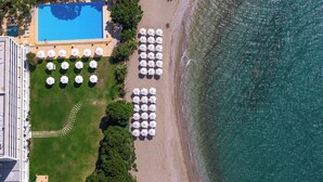 An aerial view of a beach resort with a swimming pool, umbrellas, and a clear view of the ocean. - Airotel Achaia Beach (Patras)