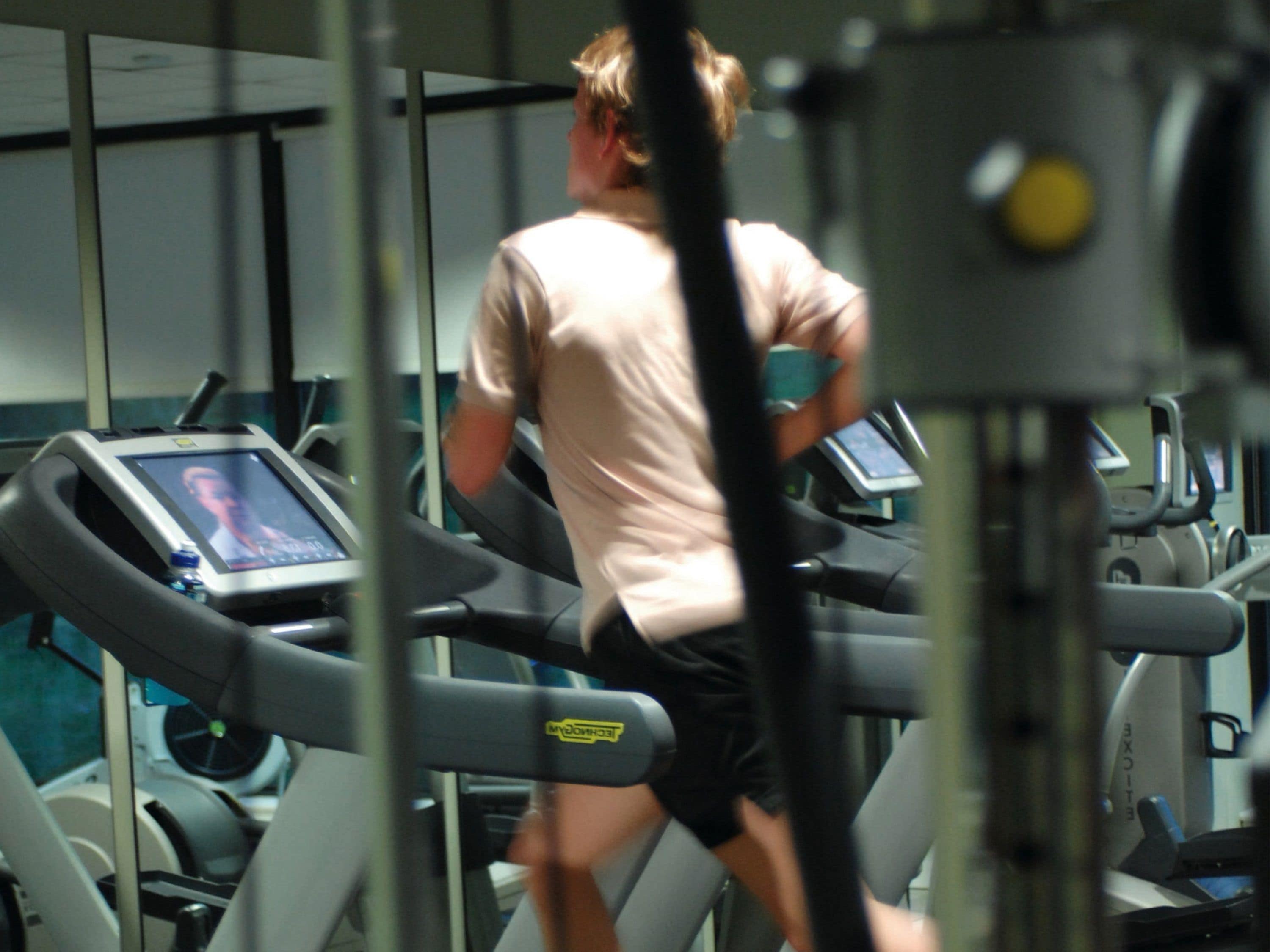 A treadmill in a gym with a digital display.