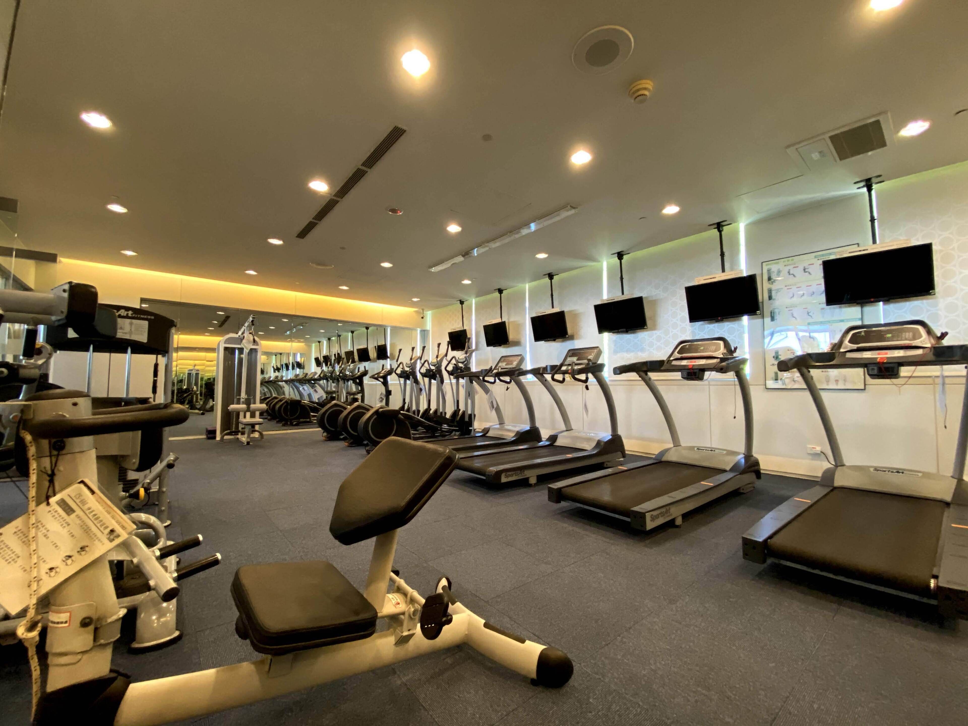 A gym with treadmills, ellipticals, and weight machines.