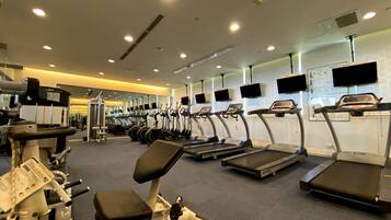 A gym with treadmills, ellipticals, and weight machines.