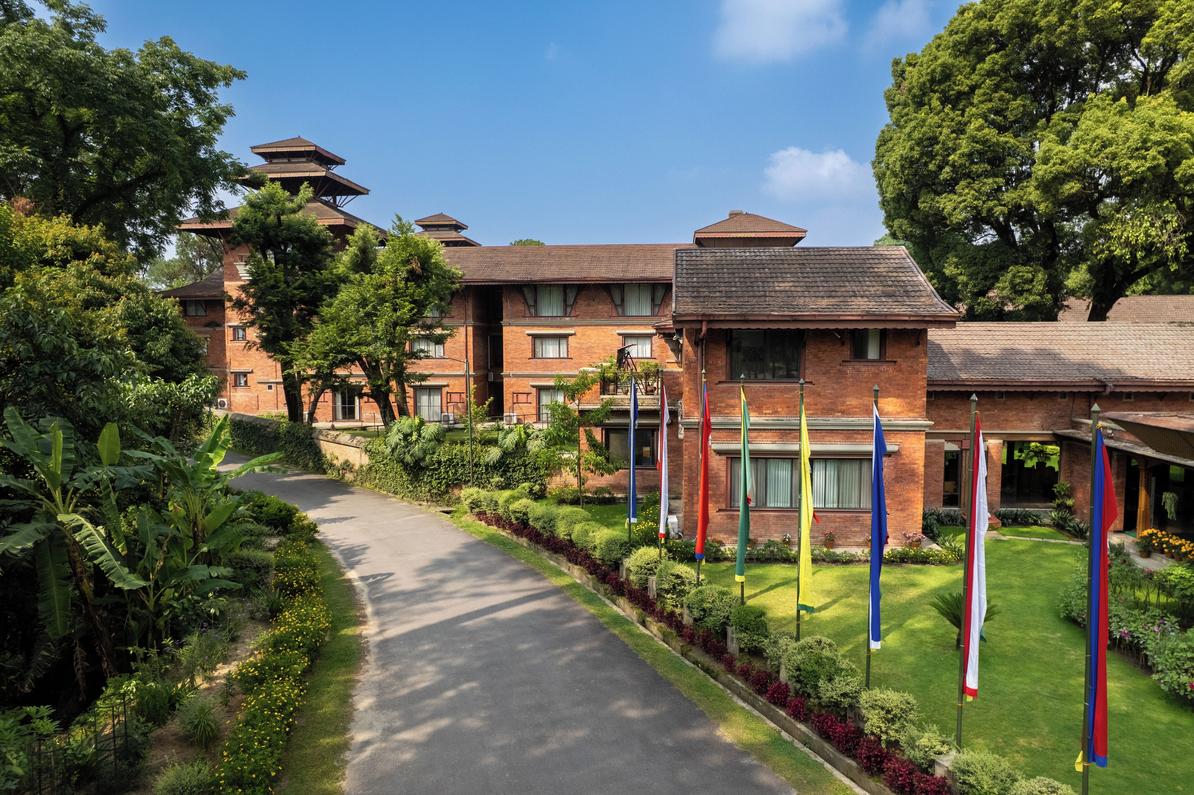 A brick building with multiple windows and a central courtyard.