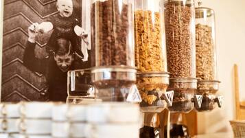 A coffee station with multiple dispensers filled with different types of coffee beans.