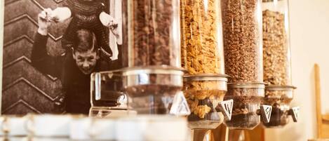 A coffee station with multiple dispensers filled with different types of coffee beans.