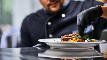 A person serving food on a plate.