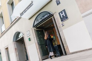 The entrance to Hotel Abba Ramblia with a clear sign above the door, a visible entrance, and a person with luggage.