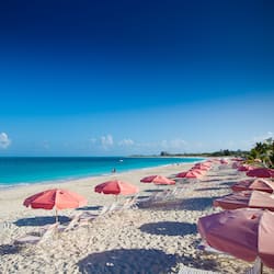 On the beach, white sand, sun loungers, beach umbrellas