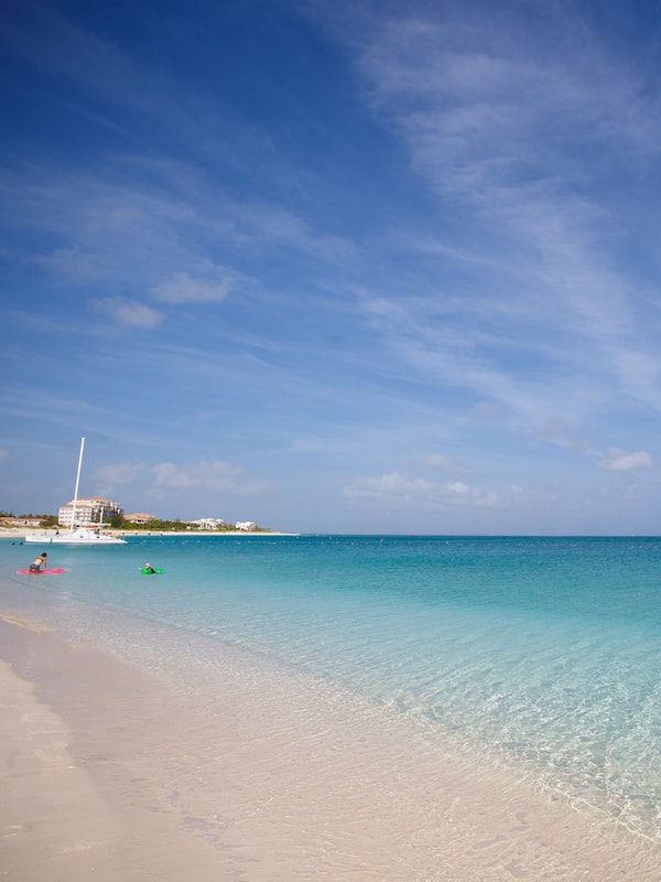 On the beach, white sand, sun loungers, beach umbrellas
