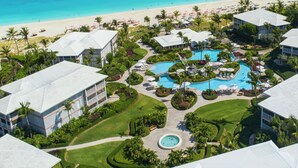 A resort with a central pool, beachfront, and multiple buildings. - Ocean Club West, Grace Bay Beach (Providenciales)