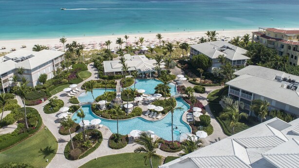 A resort with a central pool, beachfront, and multiple buildings. - Ocean Club West, Grace Bay Beach (Providenciales)