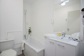 Bathtub, eco-friendly toiletries, towels