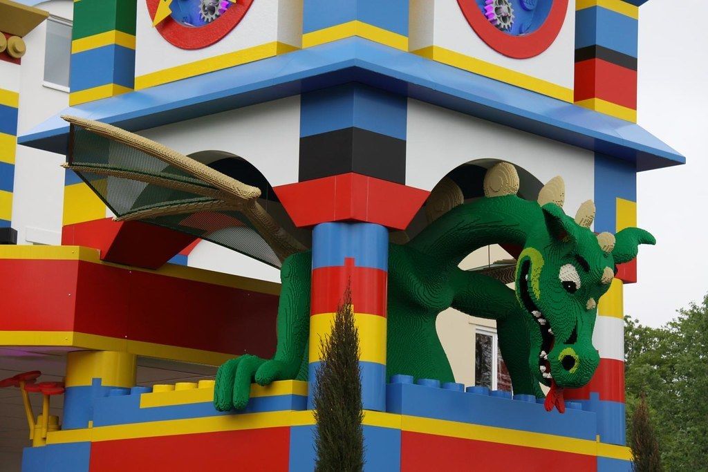 A colorful building with a dragon sculpture on the side.