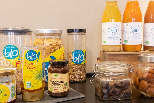 A variety of Monoprix Bio products including jars of nuts, honey, and syrups.