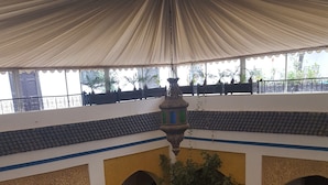 A courtyard with a fountain, arches, and tiled flooring. - Palais Didi (Meknes)