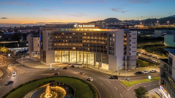 A hotel with a modern design, multiple floors, and a well-lit entrance.