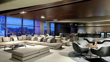 A modern living room with a sectional sofa, armchairs, and a coffee table.