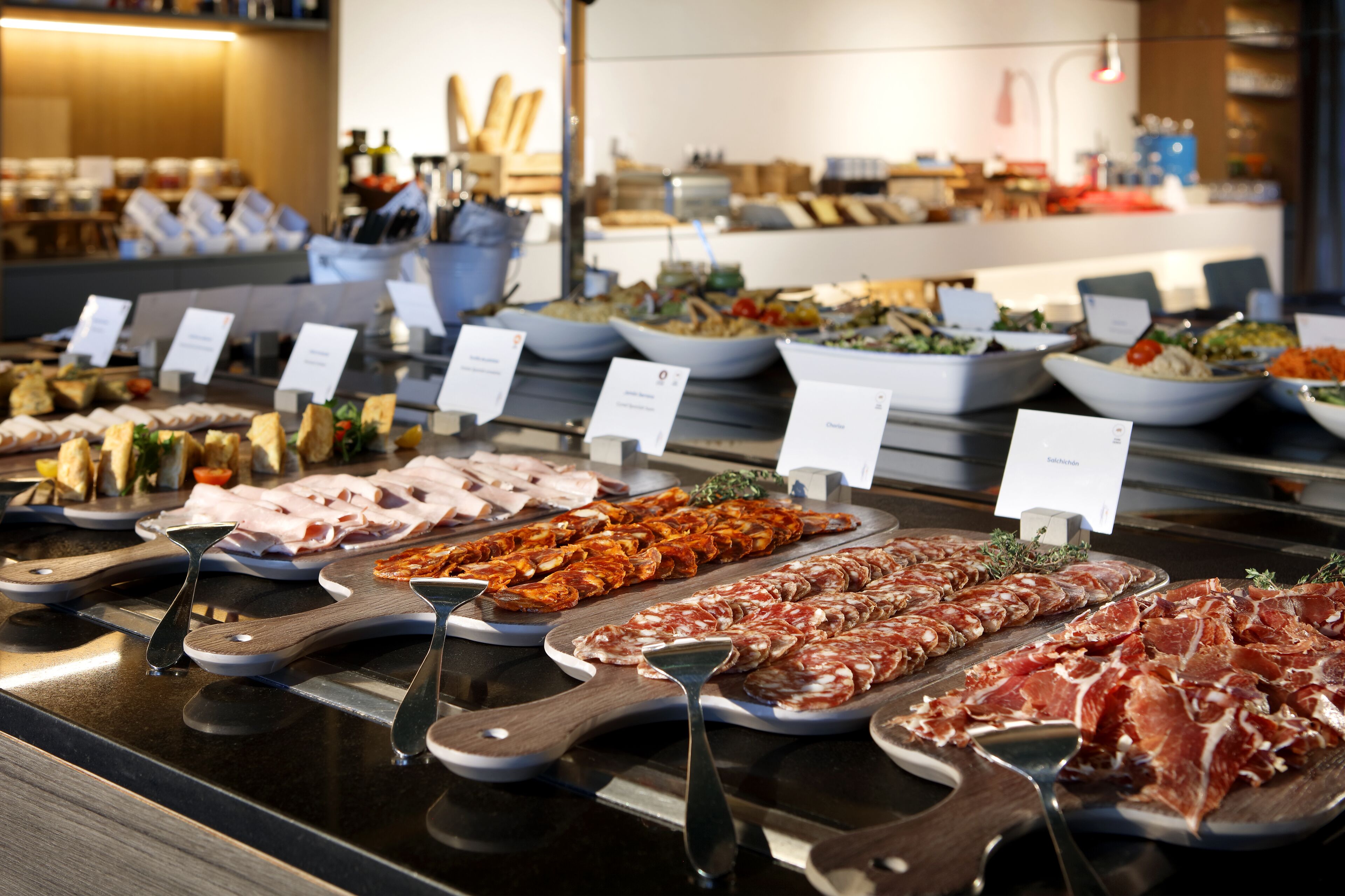 A buffet with various food items and serving utensils.