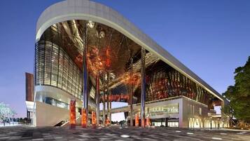 A modern building with a curved facade, large glass windows, and a spacious entrance area.