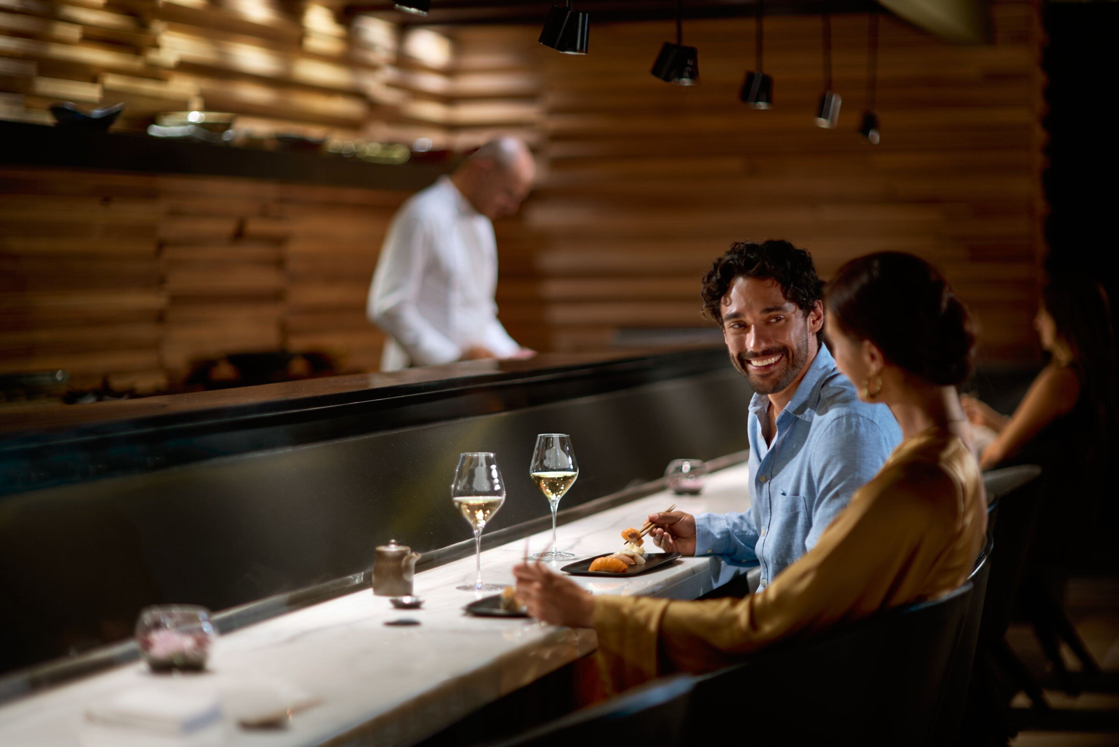 A restaurant with a wooden interior and a bar area.