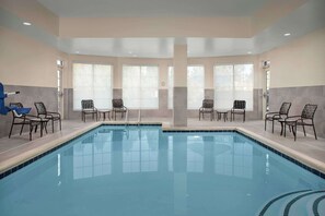 Relax by the pool surrounded by comfortable lounge chairs and tables.