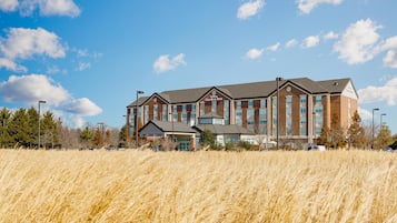 A large brick building with a sign reading 'Hilton Garden Inn.'