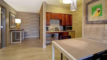 Una cocina moderna con armarios de madera, microondas y cafetera.