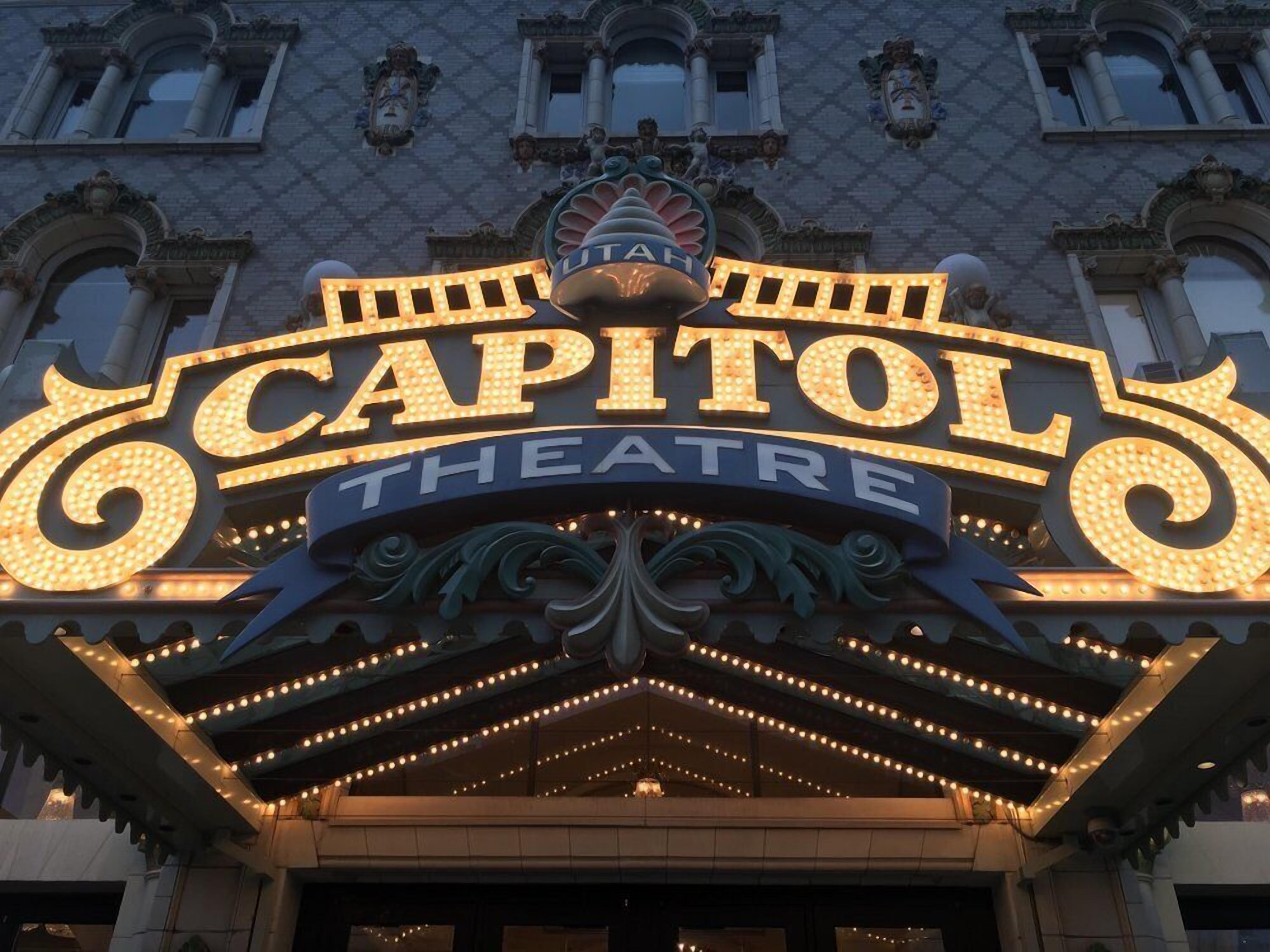 The exterior of the Capitol Theatre with ornate signage and decorative lighting.