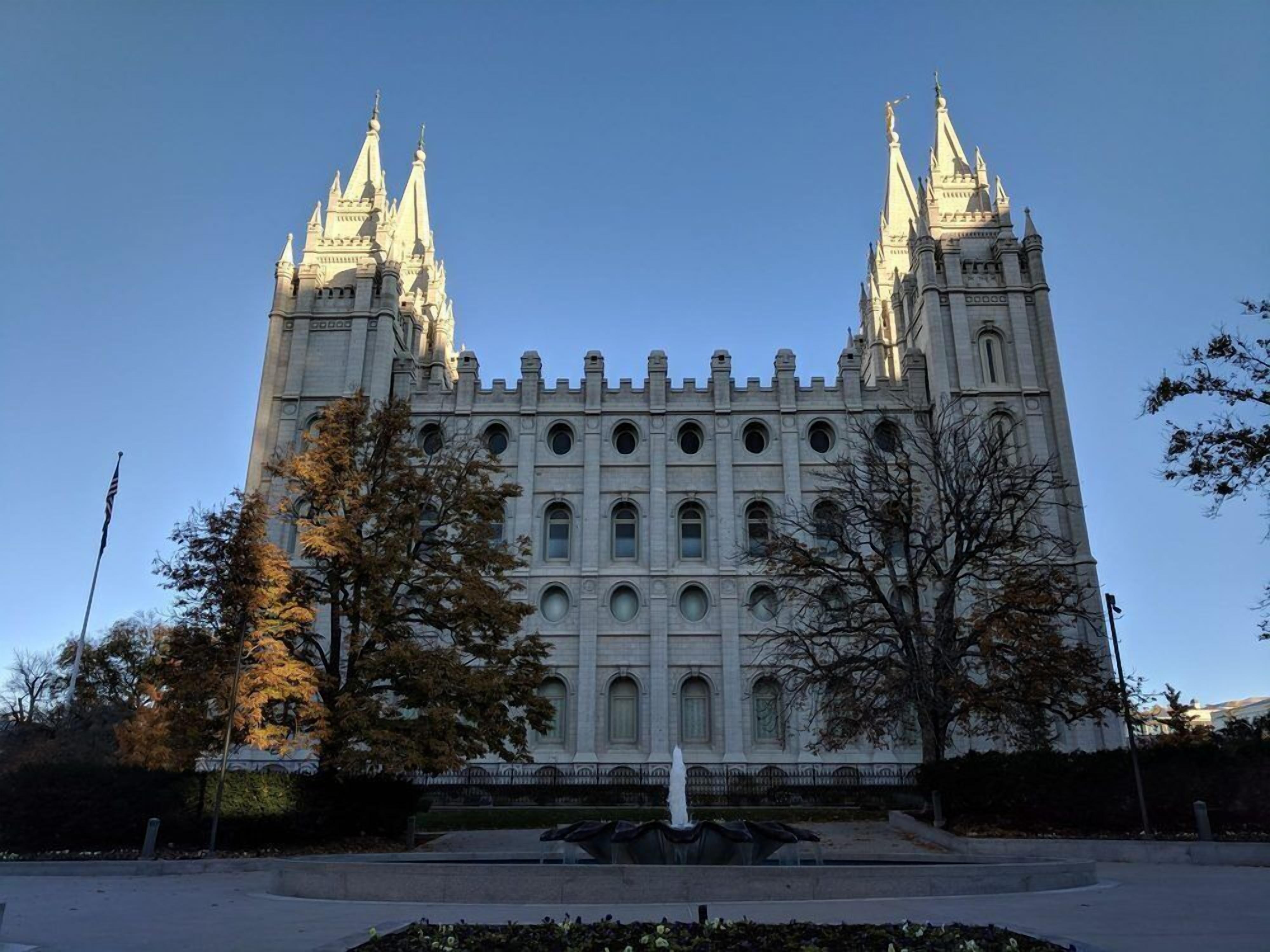 A large, historic building with two symmetrical towers and a central section with multiple arched windows.
