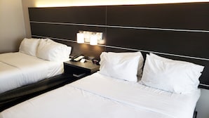 A hotel room with two beds, a nightstand, a phone, and a clock. - Holiday Inn Express Hotel & Suites San Angelo by IHG (San Angelo)