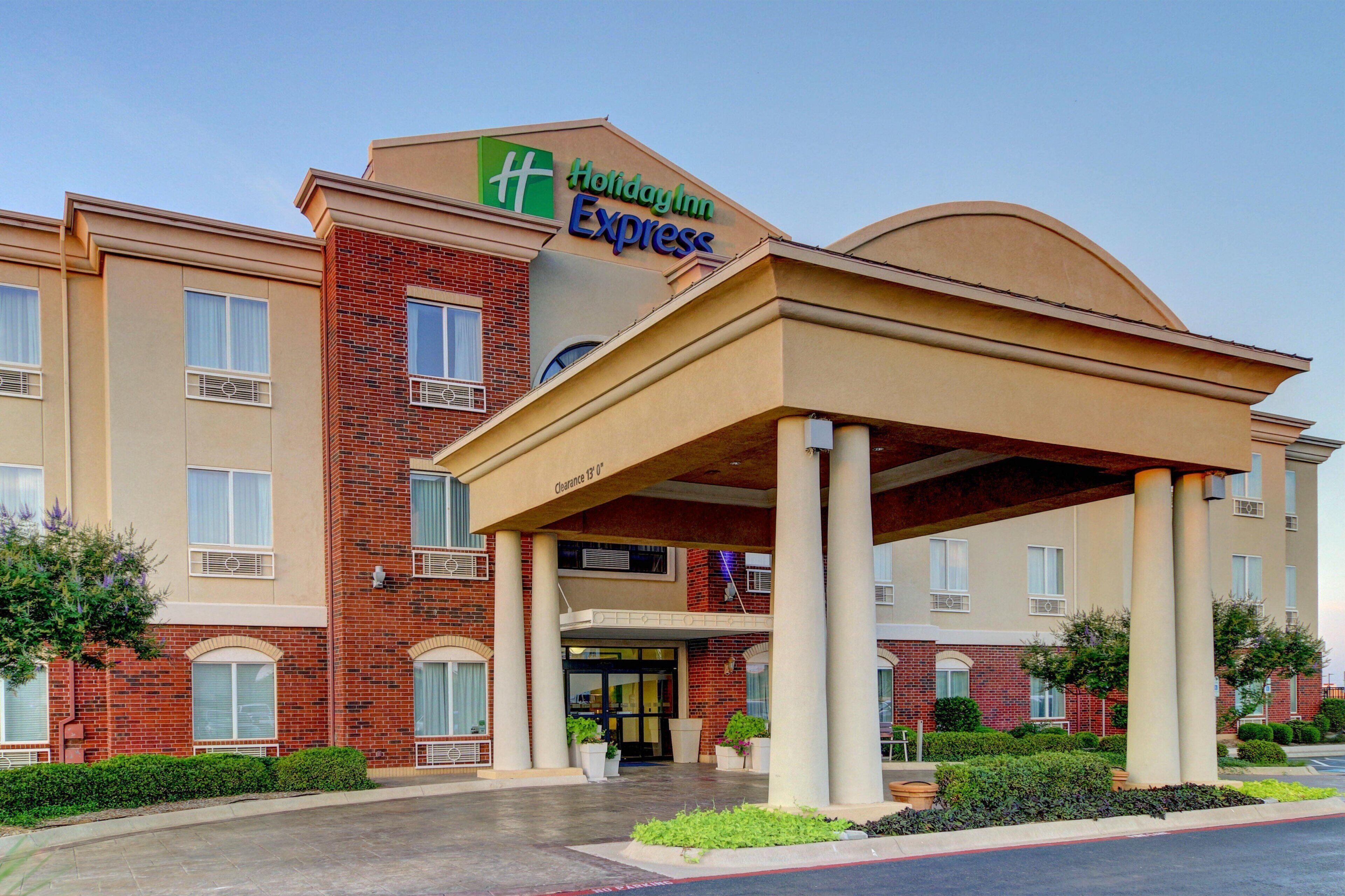 A Holiday Inn Express hotel with a covered entrance and a brick facade.