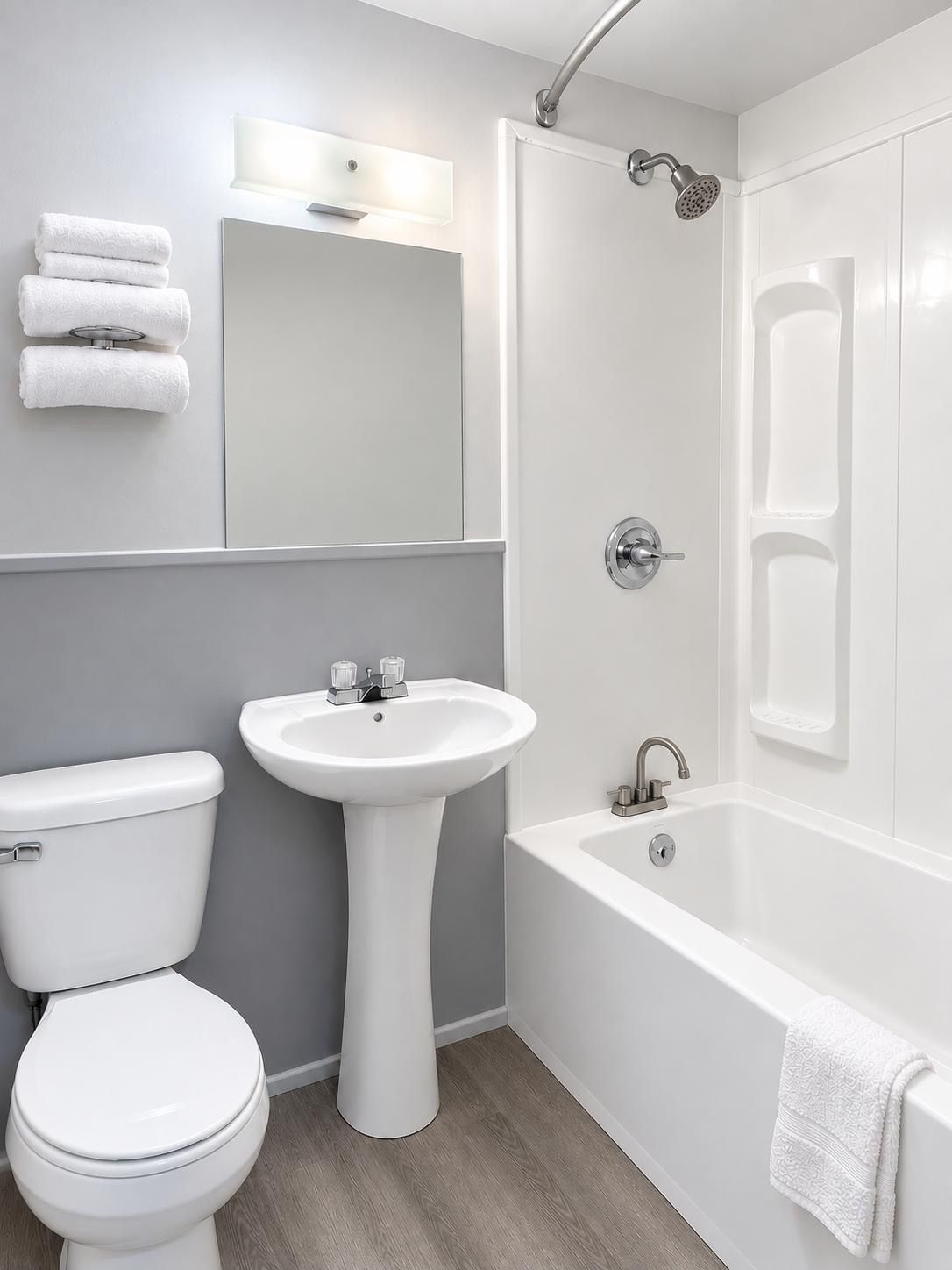 A modern bathroom with a toilet, sink, and bathtub.