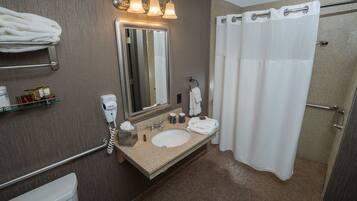 A bathroom with a sink, mirror, towel rack, and shower curtain.