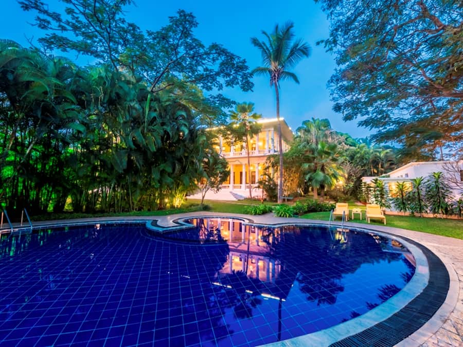 Una piscina al aire libre, sillones reclinables de piscina