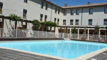 Seasonal outdoor pool, open 9:00 AM to 9:00 PM, pool umbrellas