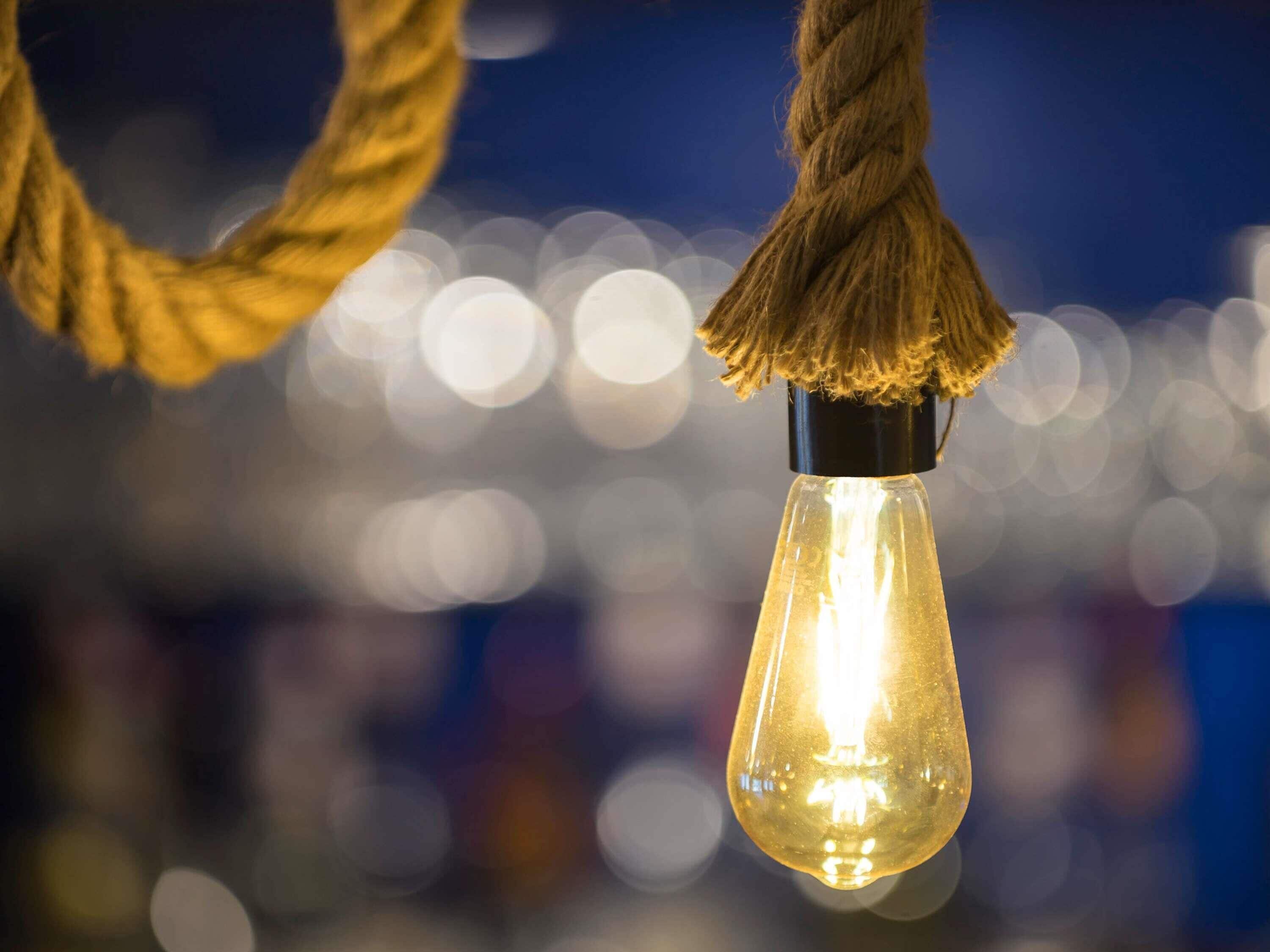 A light bulb hanging from a rope.