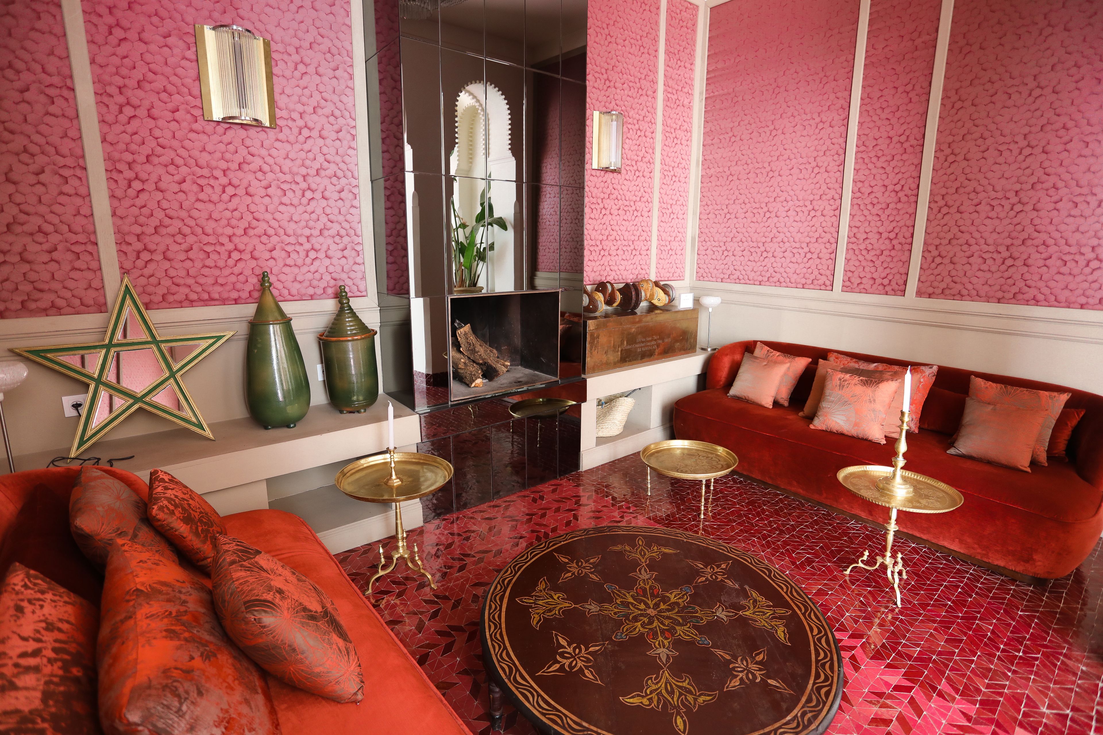 A room with a red sofa, a star-shaped decoration, and a patterned floor.